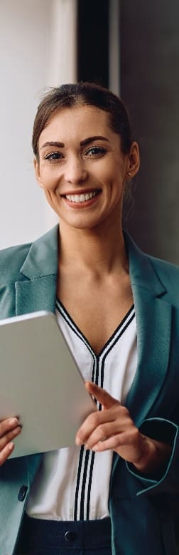 A smiling professional holding a tablet